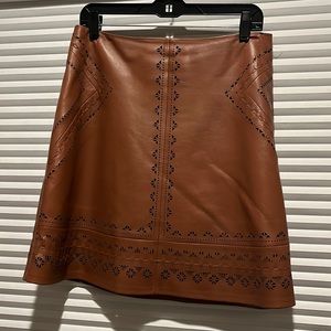 Brown leather skirt with geometric diecuts.